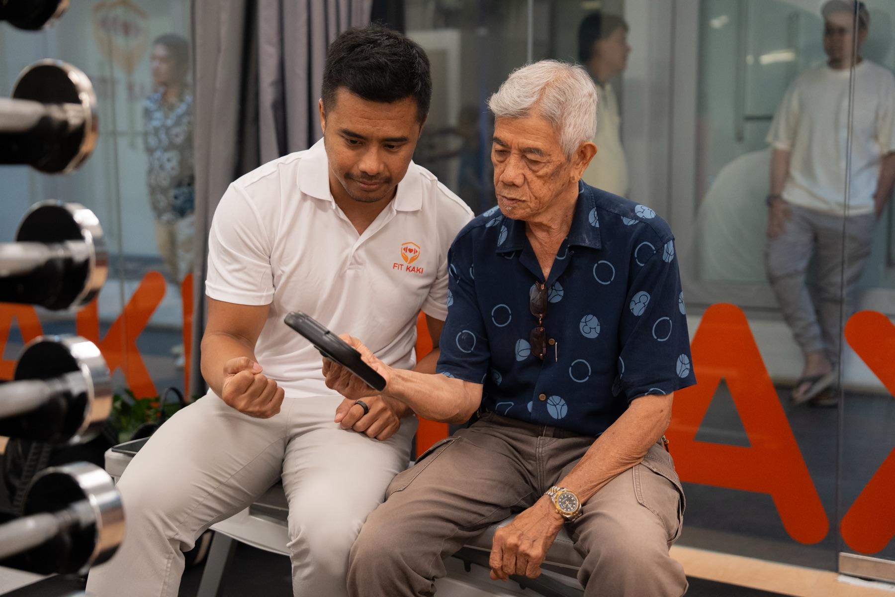 The Fit Kaki studio front at Hexacube — a coach and a senior member chatting on the bench outside